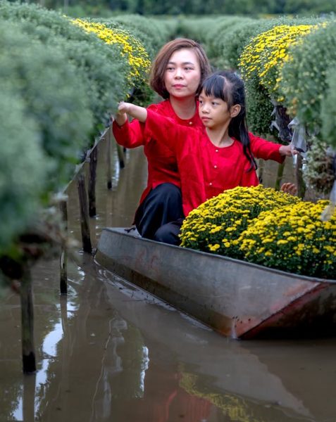 free-photo-of-mother-and-daughter-collecting-flowers-in-a-canal